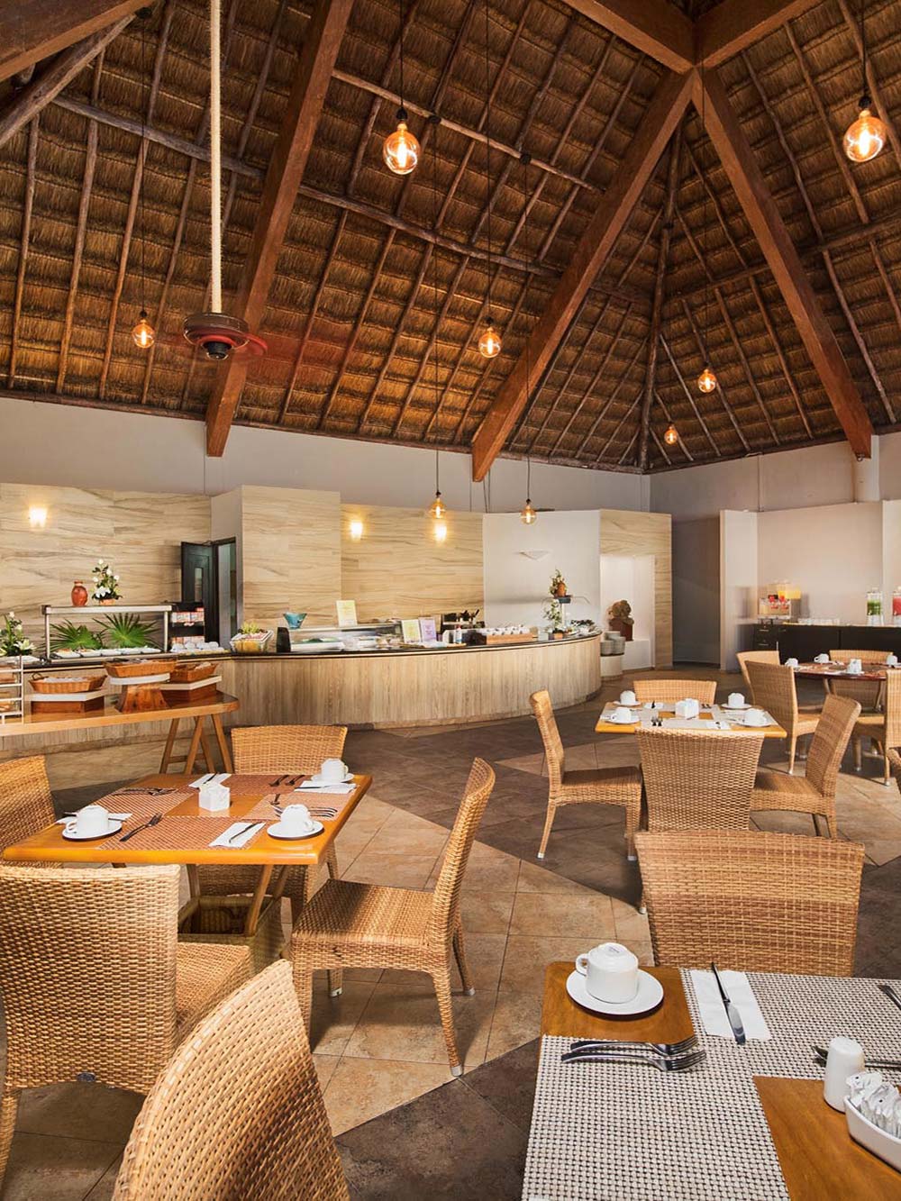 Wicker chairs with brown tables in restaurant 